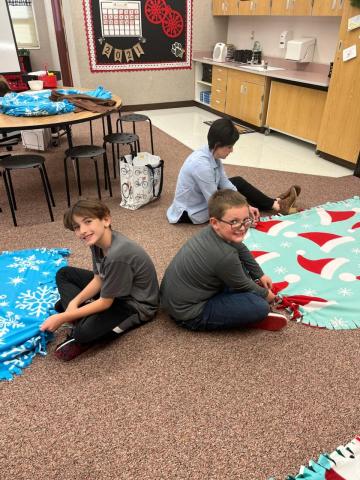 PSL Students tying blankets