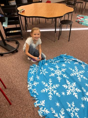 PSL student working on a fleece blanket.
