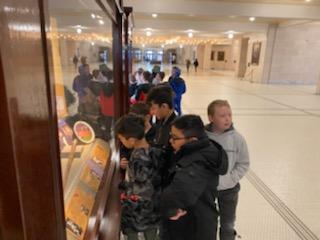4th graders looking at a display case