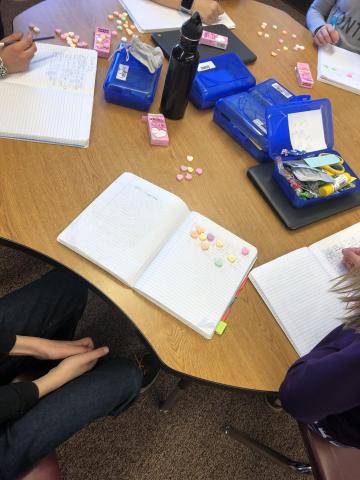 5th grade table writing and using their candy hearts.