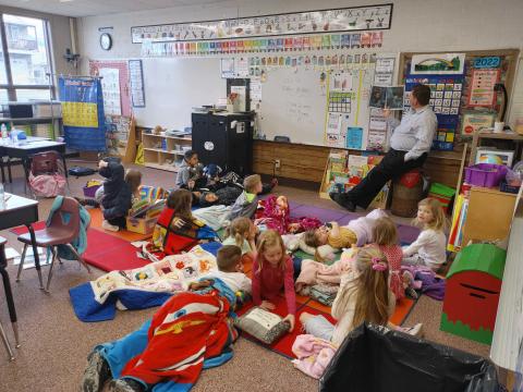 Mr. Elliott reading a book to his class. 