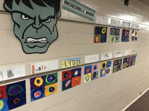 5th graders finished Kandinsky Circles artwork in the hallway
