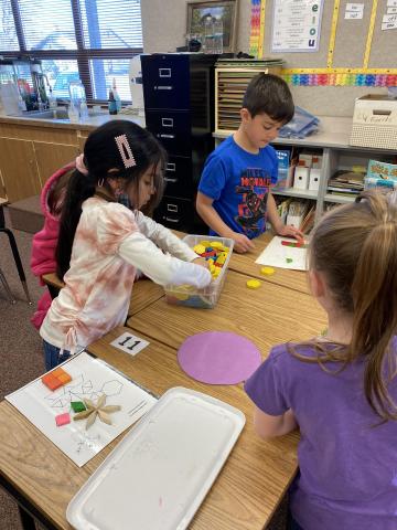 First graders working as a team to find the right shapes