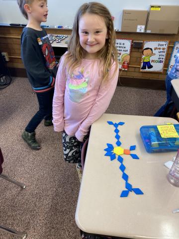 First grader showing off her own shape creation
