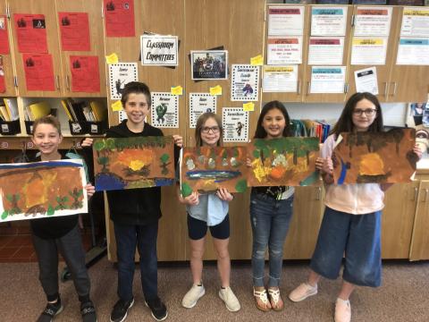 5th graders with their artwork
