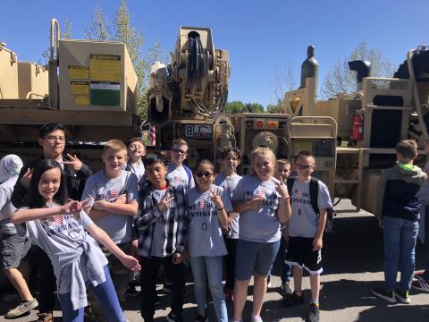 5th graders in front of military machinery