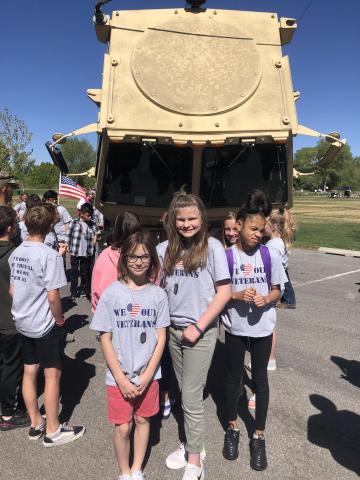 5th graders in front of a tank