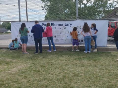 family and friends viewing the wall of honor for the veteran's walk