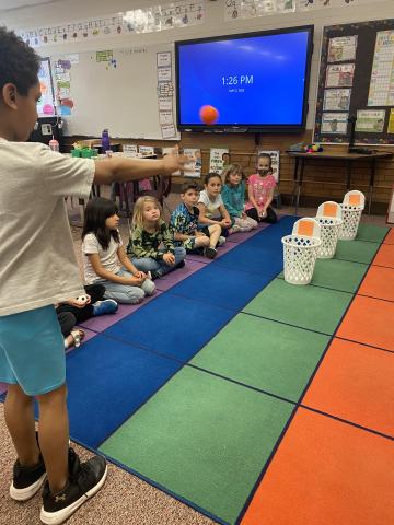 First grader throwing for the ball toss game