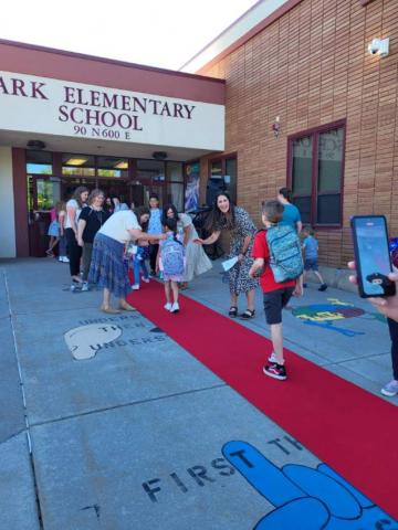 Students walking the red carpet into school