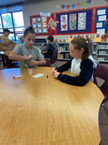 5th graders performing a science experiment