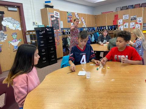5th graders performing a science experiment