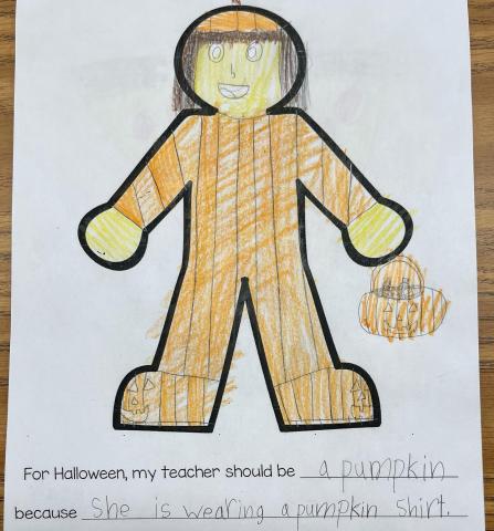 For Halloween, my teacher should be a pumpkin because she is wearing a pumpkin shirt today