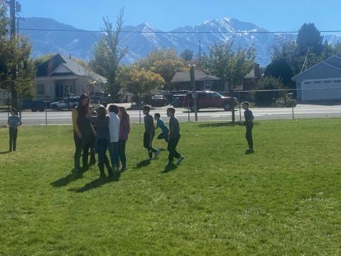 5th graders playing football with Mrs. Hughes