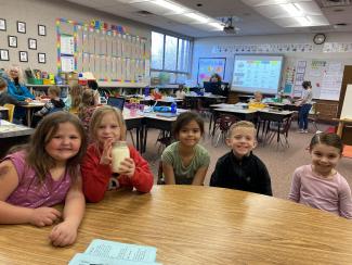 First Grade Friends showing off the butter they made