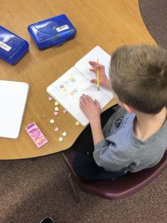 5th grader using his candy hearts