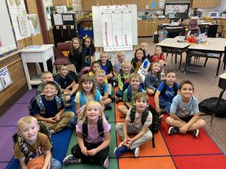1st grade students with their Apple graph